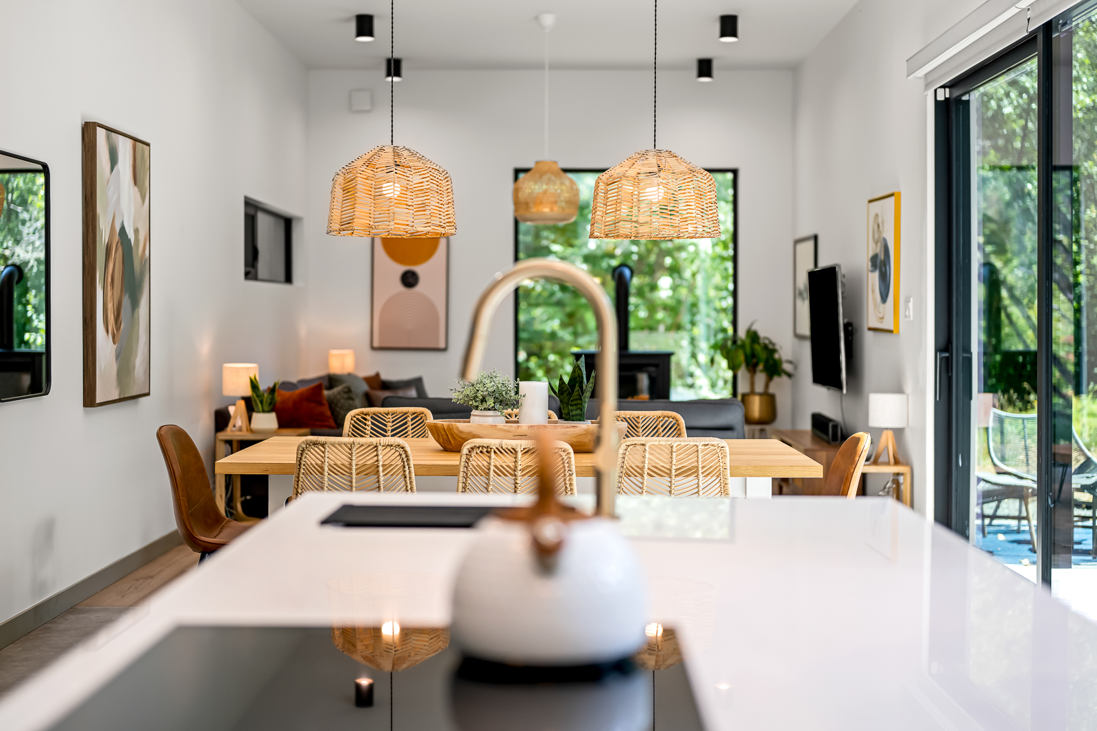 The great room — open-concept living, dining, and kitchen with floor-to-ceiling glass